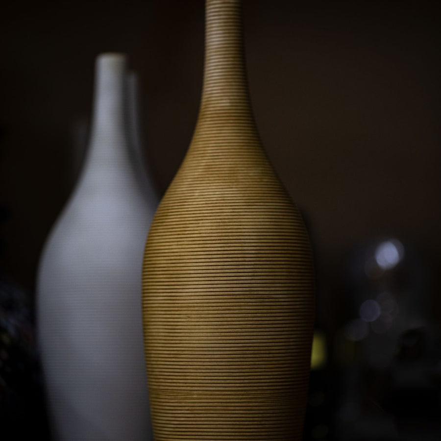 A ceramic vase finished in gold and white.