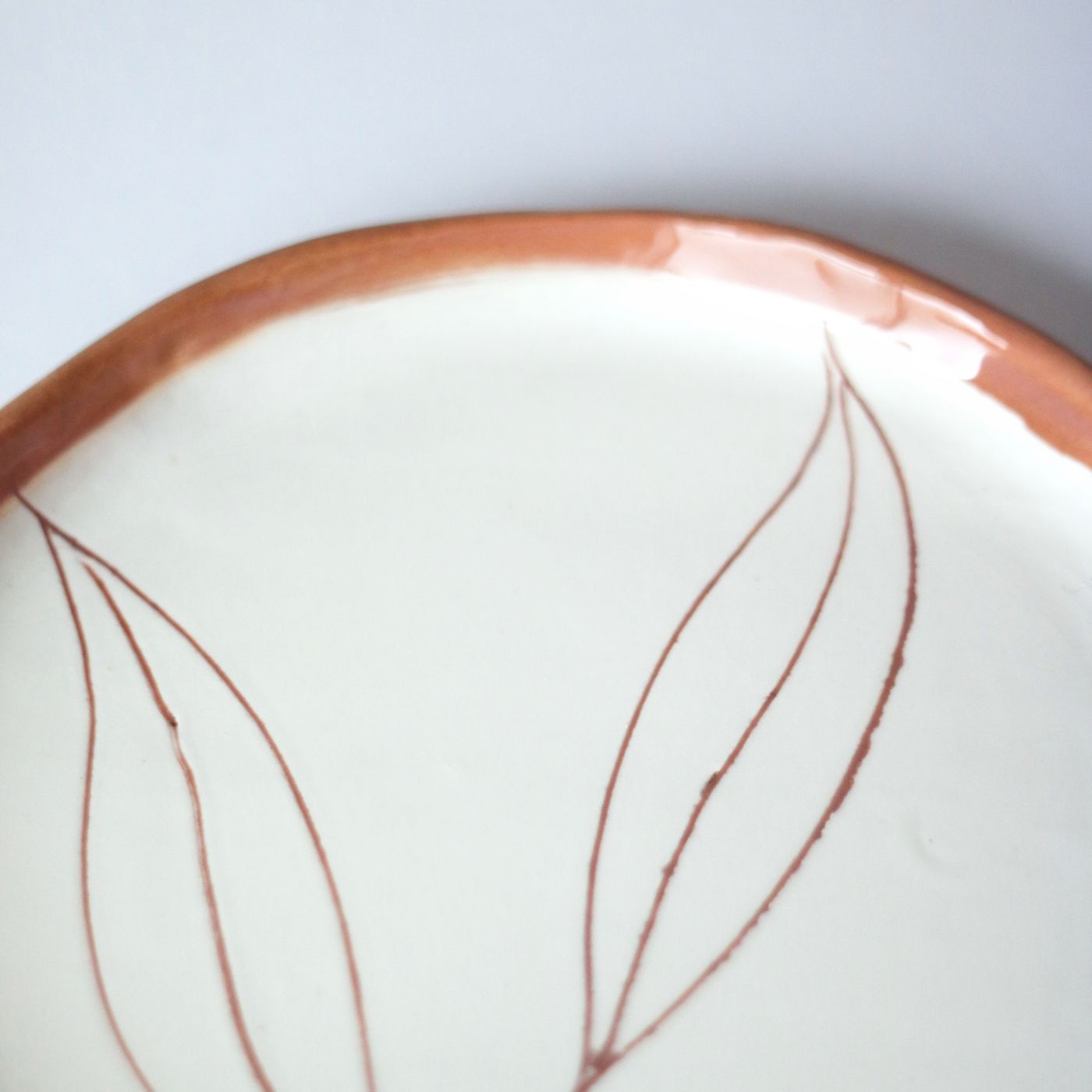 A decorated porcelain plate, photographed plainly so the surface reads clearly.