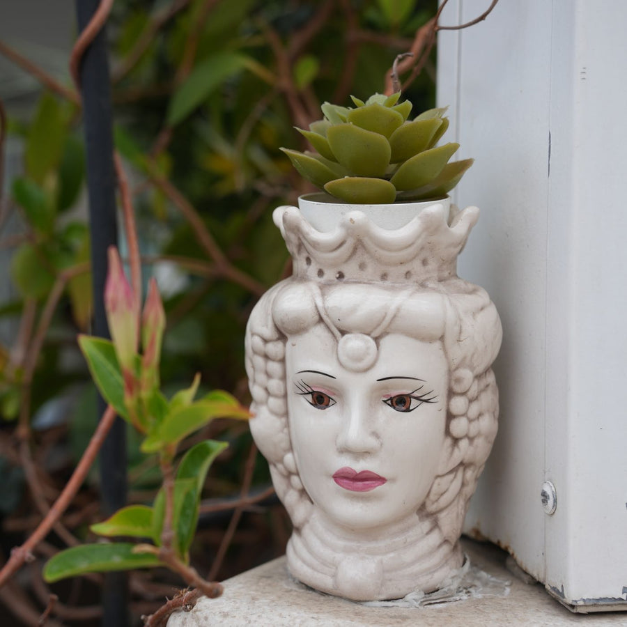 A Sicilian face planter, shown here with a succulent growing out of the top.