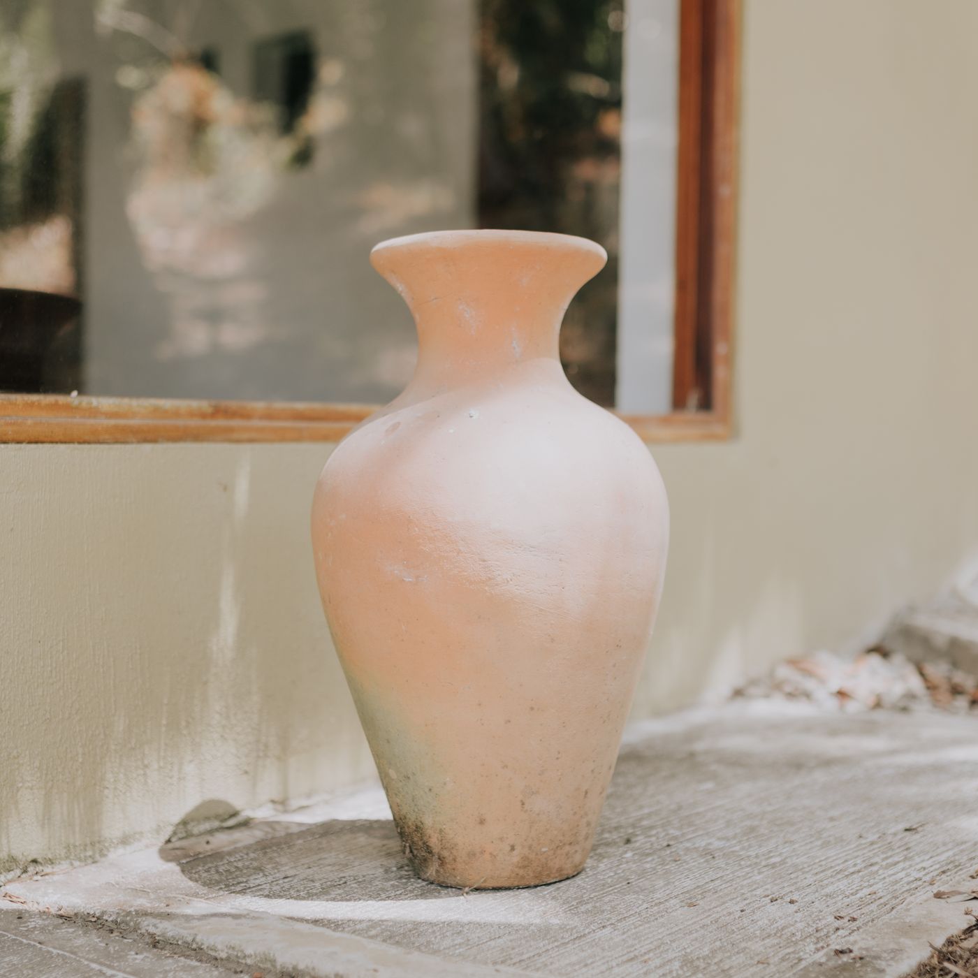 A classic terracotta vase photographed outdoors in natural light.
